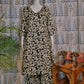 Front view of black cotton quad set with floral printed top and pant