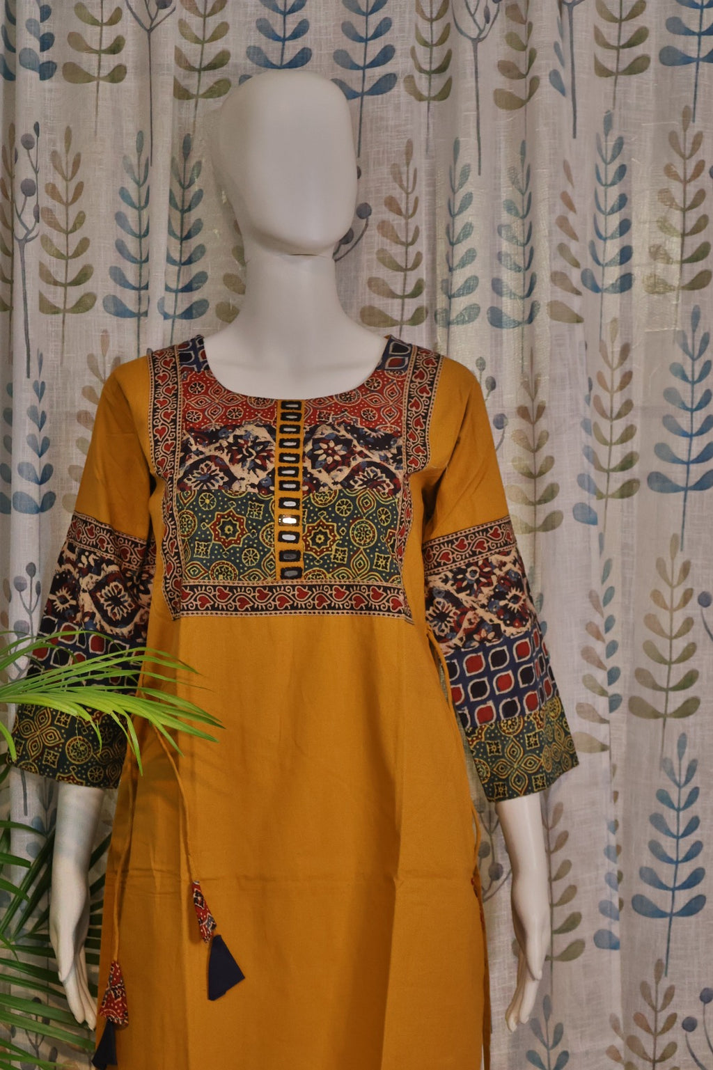 Handcrafted yellow kurti with mirror work and artisan-inspired design