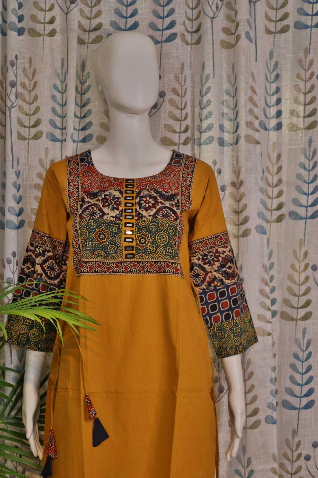 Handcrafted yellow kurti with mirror work and artisan-inspired design